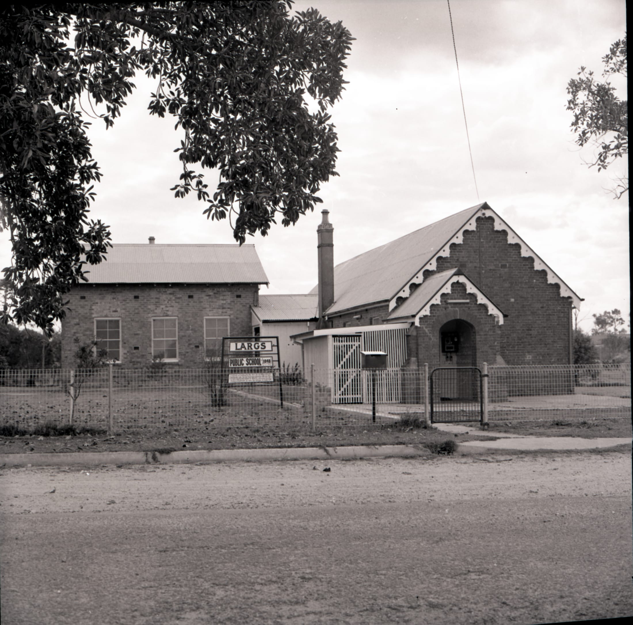 Historic black and white photograph of Largs Public School viewed from the street.